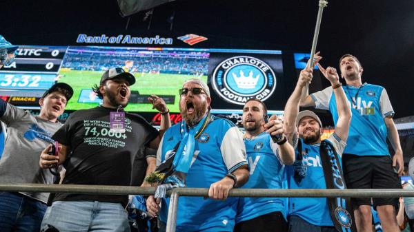 Fans cheer before an MLS soccer match between Charlotte FC and the LA Galaxy in Charlotte, N.C., Saturday, March 5, 2022. (AP Photo/Jacob Kupferman)