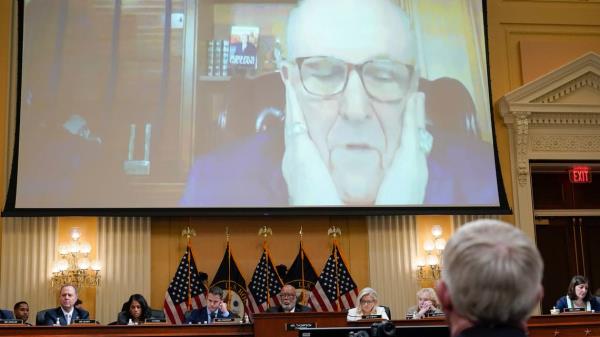 FILE - A video of Rudy Giuliani is displayed on a screen, as the House select committee investigating the Jan. 6 attack on the U.S. Capitol co<em></em>ntinues to reveal its findings of a year-long investigation, Thursday, June 23, 2022, at the Capitol in Washington. (AP Photo/J. Scott Applewhite, File)